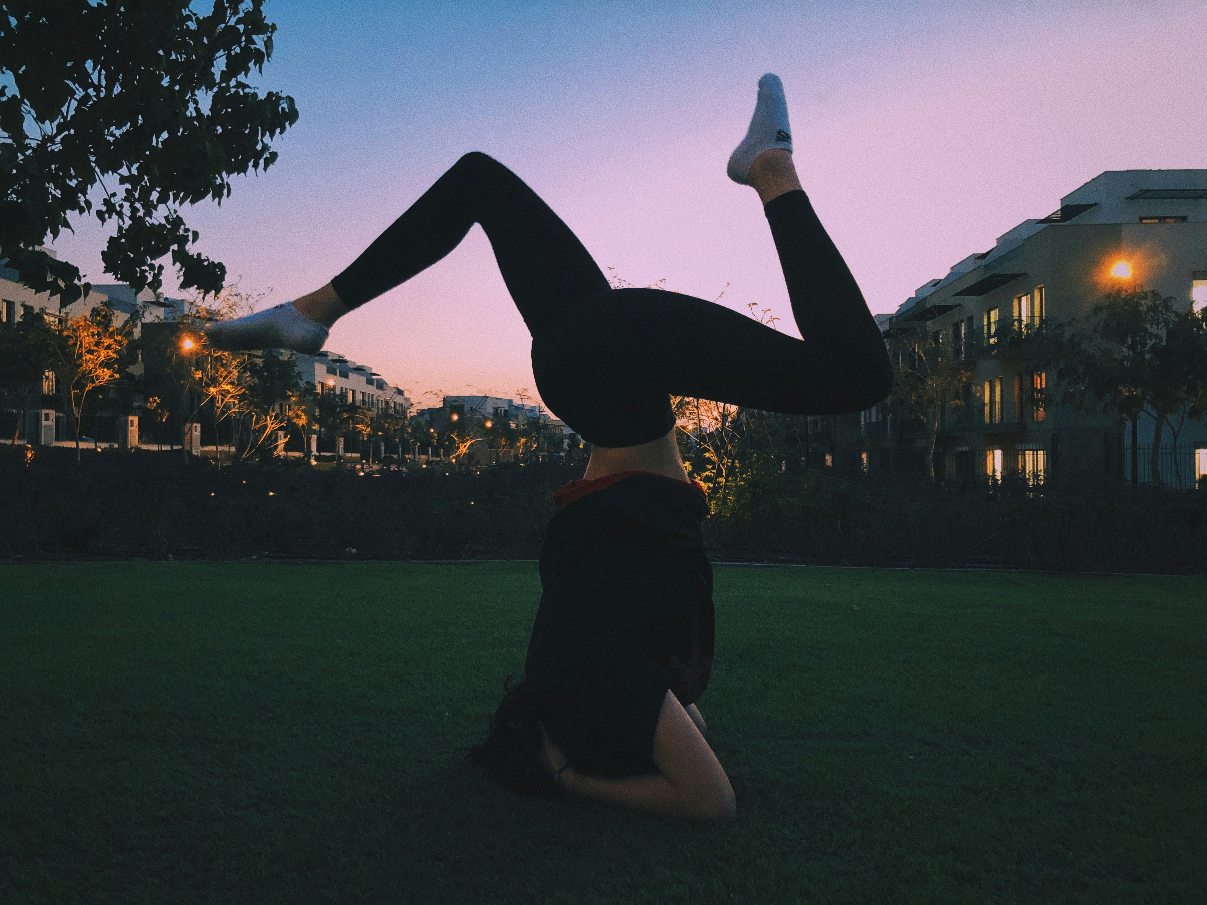 woman in black shorts and black shirt raising her hands